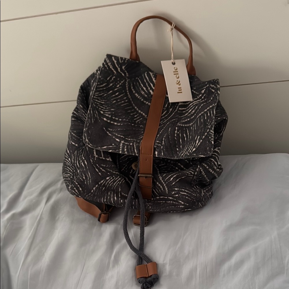Navy/Brown Paisley Backpack with Leather Accents. Drawstring closure/magnet clip